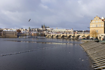 Snowy freeze Prague Lesser Town with gothic Castle and Charles Bridge, Czech republic