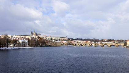 Fototapeta na wymiar Snowy freeze Prague Lesser Town with gothic Castle and Charles Bridge, Czech republic