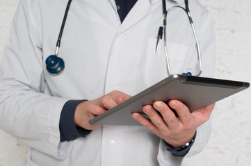 Doctor filling medical online form in the laptop tablet. The  works at the hospital