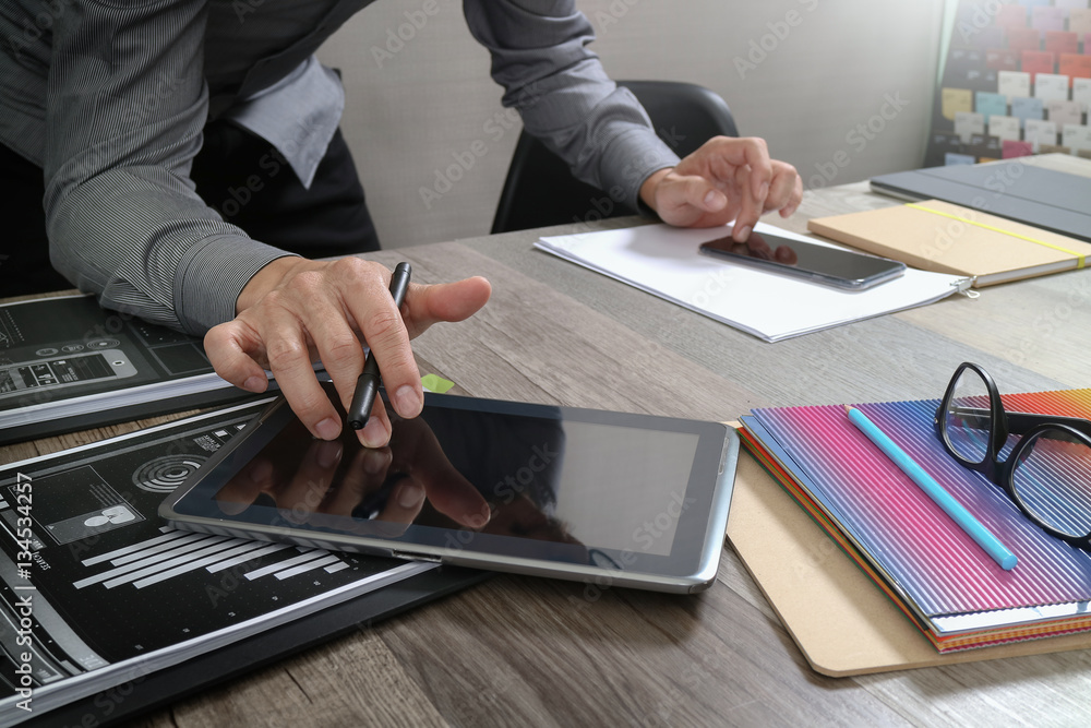 Aufkleber website designer holding smart phone and working computer digita