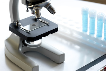 doctors desk with microscope and test tubes