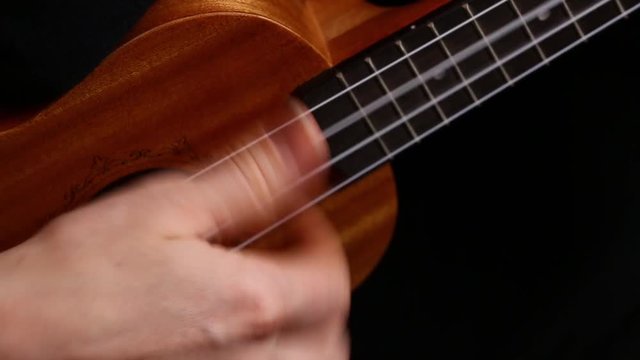 close up playing ukulele