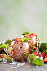 Moscow mule cocktail with lime and strawberry