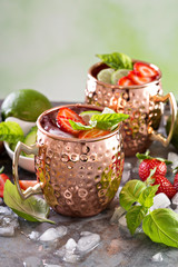Moscow mule cocktail with lime and strawberry