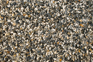 Seamless background texture of red granite chips panel