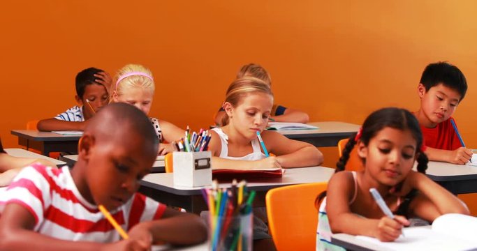 School kids doing their homework in classroom at school 4k