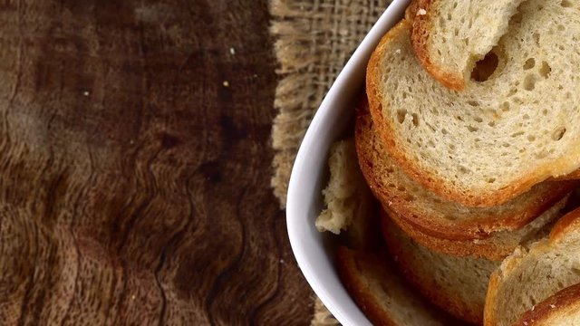 Bread Chips as not loopable 4K UHD footage (rotating on a wooden plate)