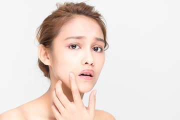 beauty girl of half latina and half asian who checks her skin, skin care, acne treatment