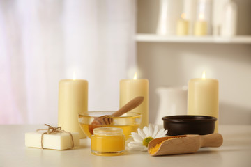 Fototapeta na wymiar Spa set with honey treatments and candles on white table