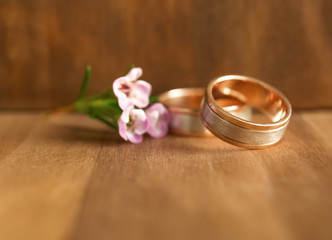 Golden wedding rings on wooden background