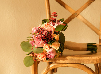 Beautiful bridal bouquet on chair, closeup