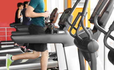 Fototapeta na wymiar Row of modern treadmills in gym