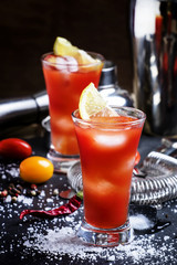 Bloody Mary cocktail with lemon, black background, selective foc