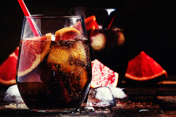 Cocktail with cola, grapefruit juice, ice cubes and liqueur, dar
