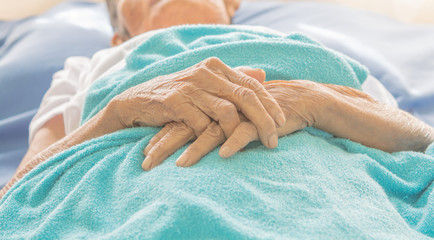 old Hand women on bed patient - Powered by Adobe