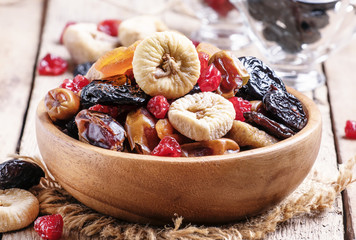 Healthy food: mix from dried fruits in bowl, old wooden backgrou - obrazy, fototapety, plakaty