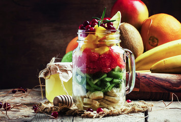 Spring vitamin salad made from fruits, old wooden background, se