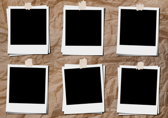 Blank classic film photo frame with tapes, on crumpled paper board