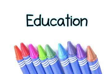 Education text with Selective focus Crayons background
