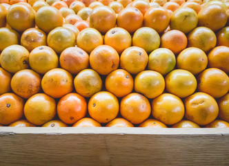 Stack of Oranges on Fruit Shelf Stand with Wood for Copy Space a