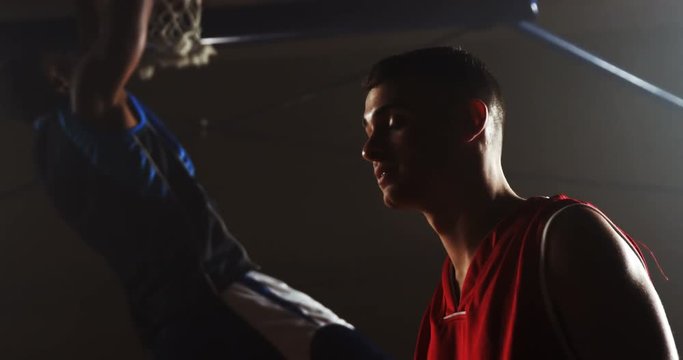 Portrait of basketball player looking at competitor in basketball court 4k