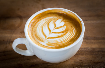 cup of latte coffee on wood table