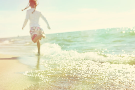 Soft image of a child running on the beach, defocused image, ins