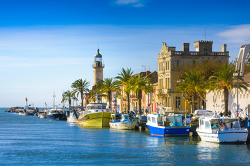 Grau du Roi city and harbor during a sunny day in France - obrazy, fototapety, plakaty