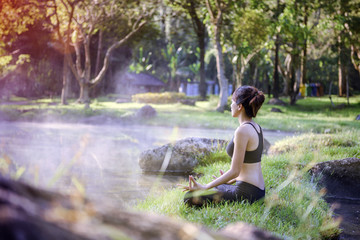 yoga woman in natural hot spring