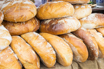 Freshly baked traditional loaves of rye bread on stall