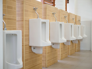 Close up row of outdoor urinals men public toilet,Closeup white urinals in men's bathroom, design...