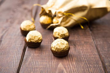 gold bag of chocolates. candy in Golden foil with copy space