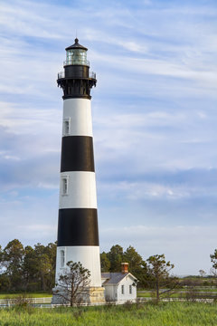 The historic Bodie Island Lighthouse stands tall with white and black stripes at Cape Hatteras National Seashore on the Outer Banks of North Carolina.