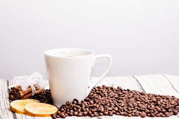 Cup of coffee with coffee beans on a white background