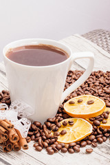 White cup and coffee beans on the table