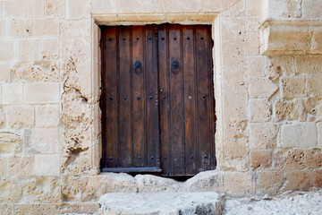 Fototapeta na wymiar Vintage wooden door - a fragment of an ancient monastery. Cyprus. Ayia Napa