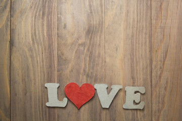 background with a heart and the words love on wooden table