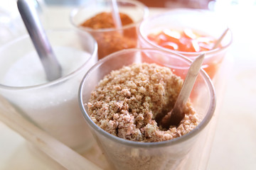 Seasoning set for noodle Thai food style, sugar, vinegar, chopped peanuts and cayenne pepper,selective focus , light effect.
