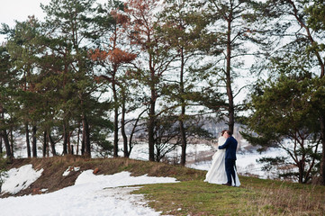 Amazing young wedding couple in love at winter frost and sunny d