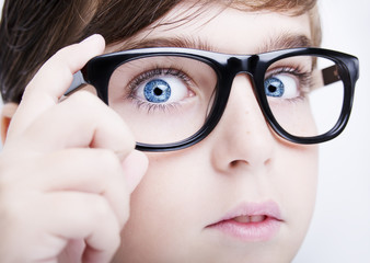 Fototapeta premium Portrait of a boy wearing glasses close, macro studio shot