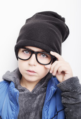 Handsome boy is wearing black cap and eyeglasses. 