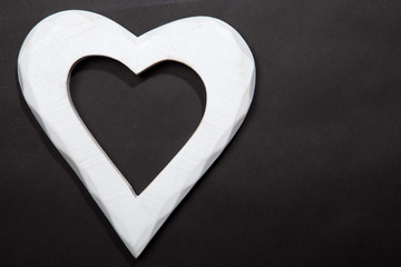 Holidays gift and heart on a black background. Valentines day