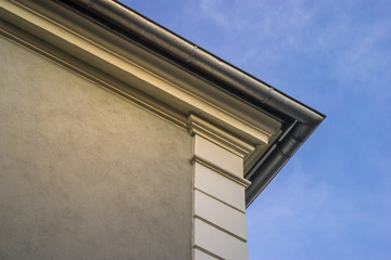 Corner of a historical house with a silver gutter