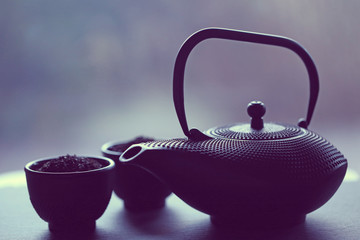 Black teapot  and bowls   in an Asian style. Asian tea set