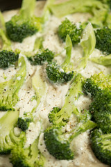 Pastry Dough in Tray Topped with Fresh Broccoli