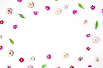 Frame made of chamomile buds, wildflowers, leaves, petals on white background. Flat lay, top view