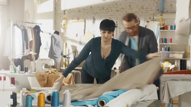 Time-Lapse of a Fashion Designer/ Dressmaker/ Seamstress Working in a Sunny Studio. They Work on a Sewing Machine, Choose Fabrics, Templates, Sketches.  Shot on RED EPIC 4K (UHD).