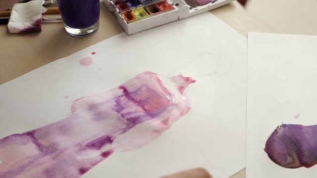 The artist mixes paint