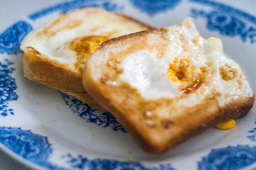 Eggy bread on the plate, photographed with natural light. Golden toast