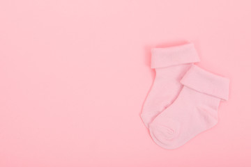 Pink baby girl socks on a pink background